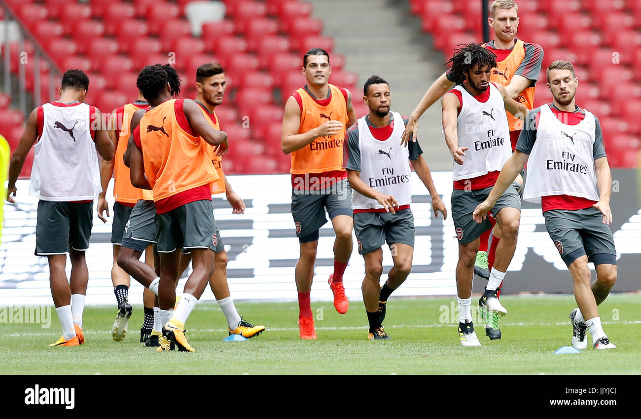 Beijing, China. 21st July, 2017. Per Mertesacker (Top) of Arsenal warm up with his teammates during a training session for the pre-season soccer match between Arsenal and Chelsea at National Stadium in Beijing, capital of China, on July 21, 2017.  Credit: Wang Lili/Xinhua/Alamy Live News Stock Photo