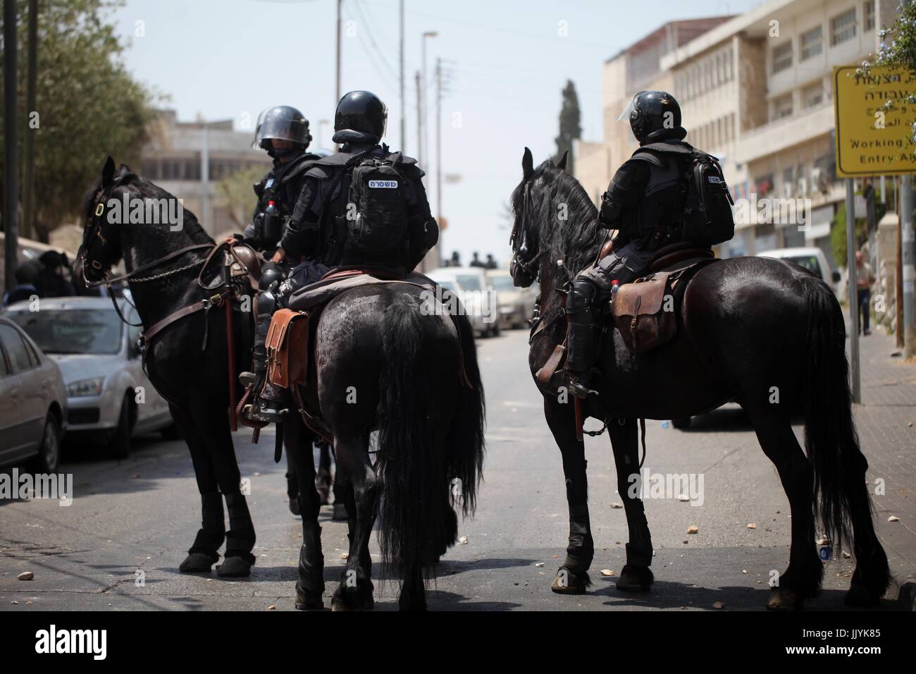 Jerusalem, Jerusalem, Palestinian Territory. 20th Aug, 2017. Horse mounted Israeli security forces patrol during clashes with Palestinian protesters following Friday prayer outside Jerusalem's Old City on July 21, 2017, after Israeli police barred men under 50 from entering the Old City for Friday Muslim prayers as tensions rose and protests erupted over new security measures at the highly sensitive Al-Aqsa mosque compound. The ban came after Israeli ministers decided not to order the removal of metal detectors erected at entrances to the Al-Aqsa mosque compound, known to Jews as the Temple Stock Photo