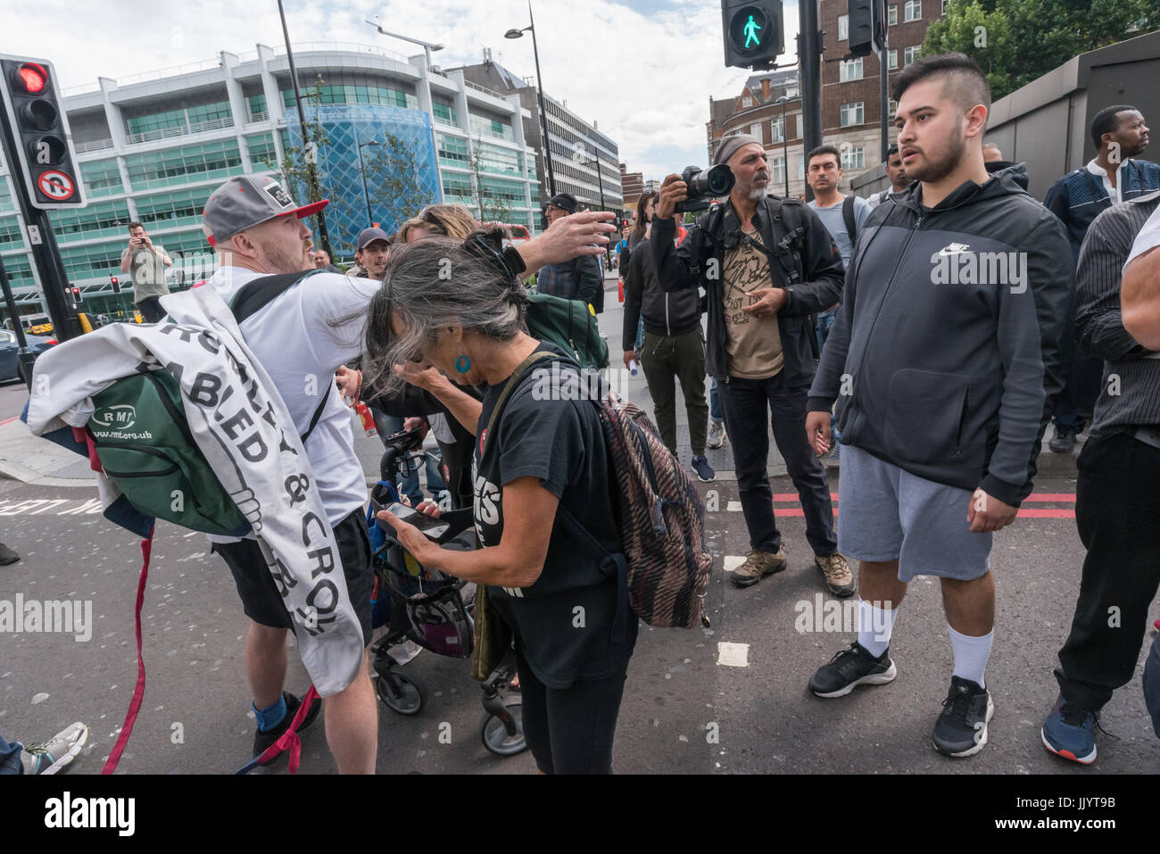 London, UK. 21st July 2017. A driver comes to argue with DPAC as they end their week of action during the London Para Athletics World Championships by blocking one carriageway of the Euston Road at Warren St for around ten minutes. They tell him that thousands of people are dyring and that everyone needs ot take action to stop it, even if it does hold up traffic for a few mintues. Credit: Peter Marshall/Alamy Live News Stock Photo