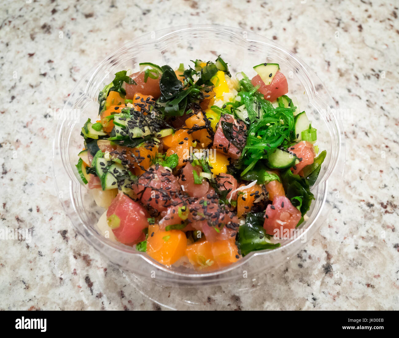 Ahi tuna and salmon poke bowl (Hawaiian fish salad) from Splash Poke in Edmonton, Alberta, Canada. Stock Photo