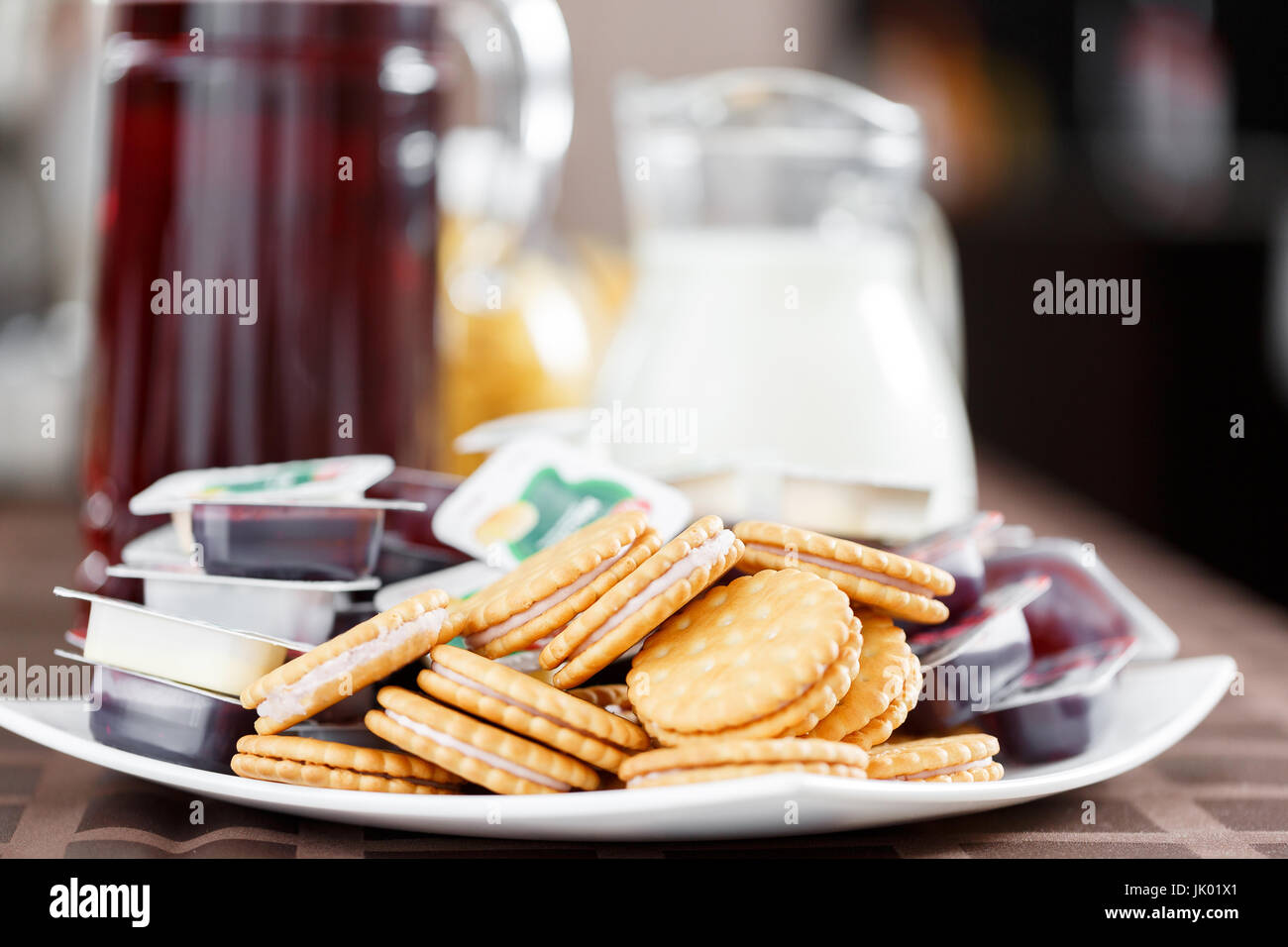 Breakfast at the hotel. cookie sandwiches with cream and jam portions