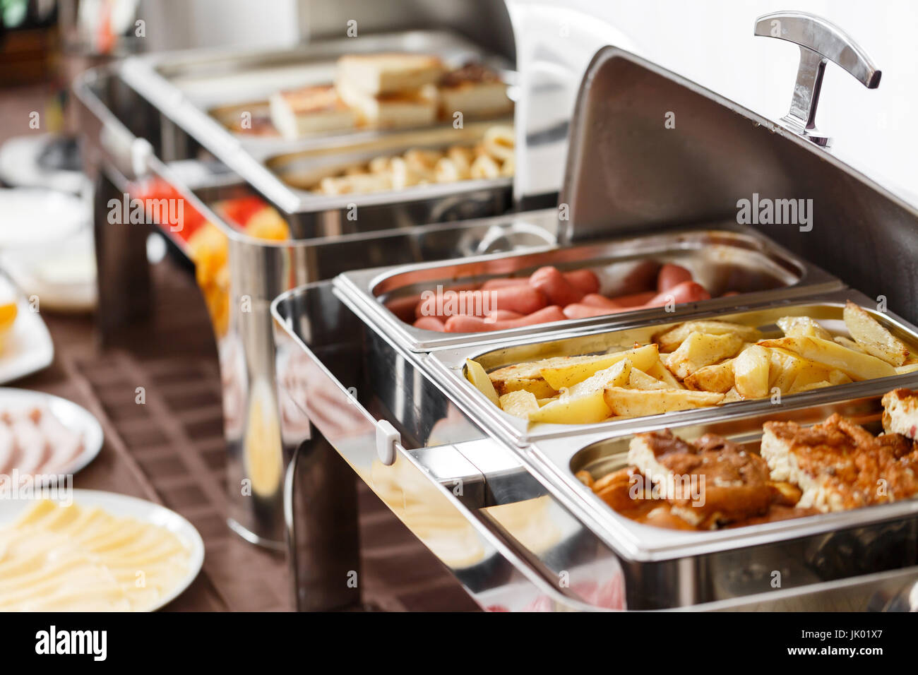 Breakfast at the hotel. fried potatoes and scrambled eggs and other hot dishes Stock Photo Alamy