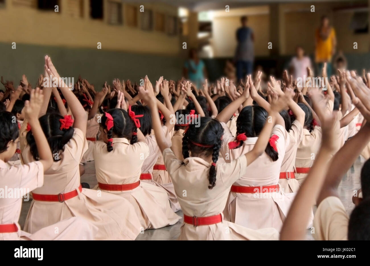 School children doing yoga with the teachers Stock Photo