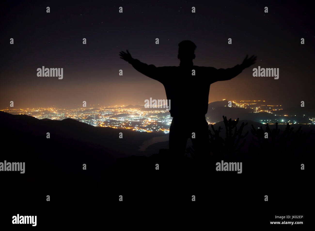 Man standing on top of mountain with arms raised hi-res stock ...