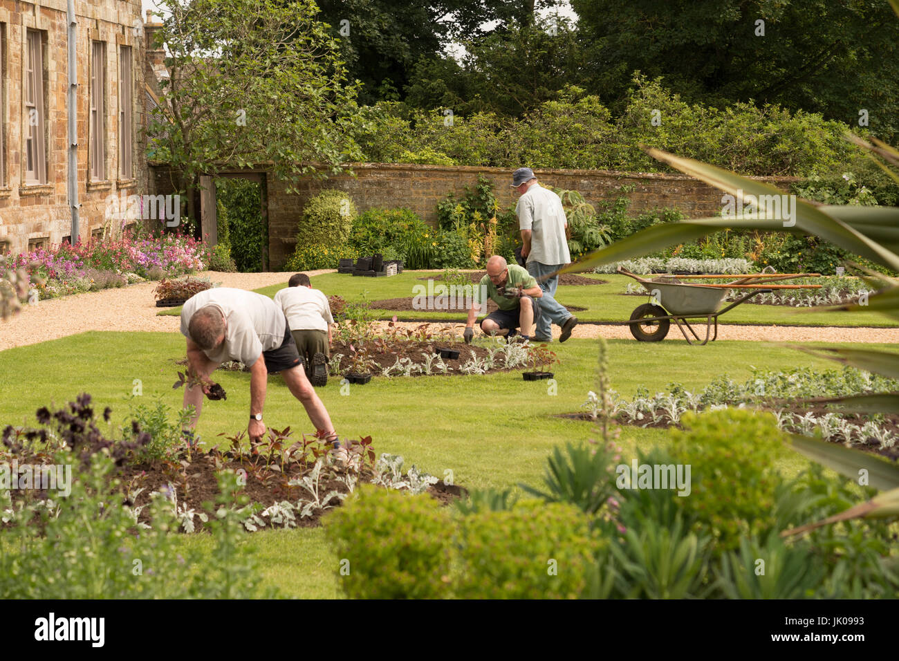 Gardeners planting out bedding plants at Canons Ashby House