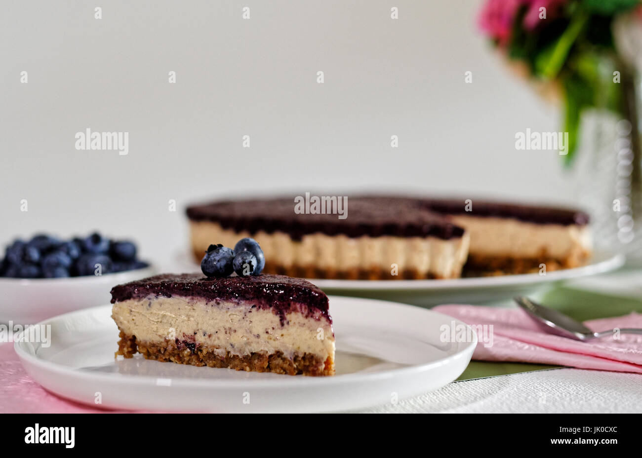 Vegan Cheesecake with blueberries, cashew nuts and dates Stock Photo