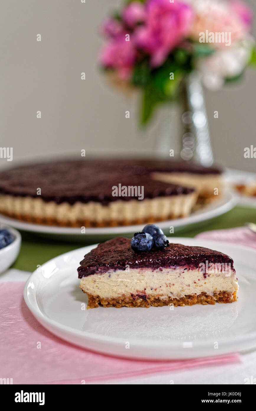Vegan Cheesecake with blueberries, cashew nuts and dates Stock Photo