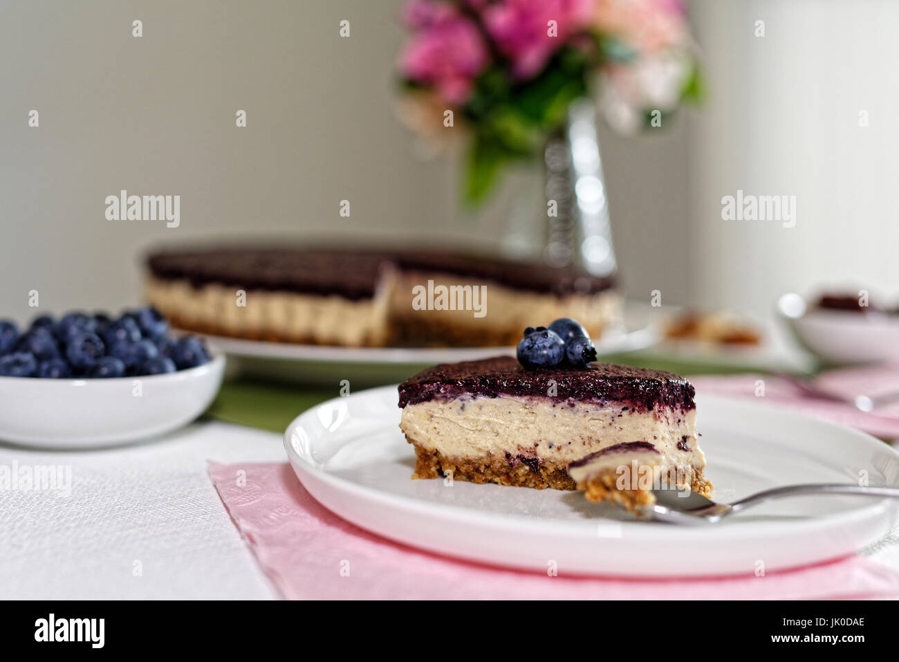 Vegan Cheesecake with blueberries, cashew nuts and dates Stock Photo
