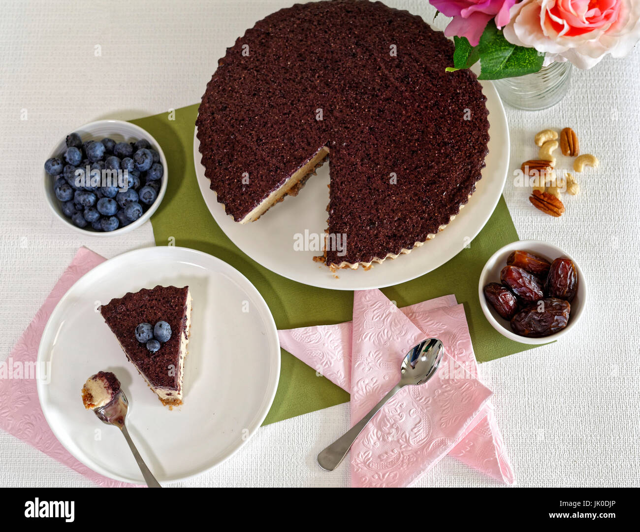 Vegan Cheesecake with blueberries, cashew nuts and dates Stock Photo