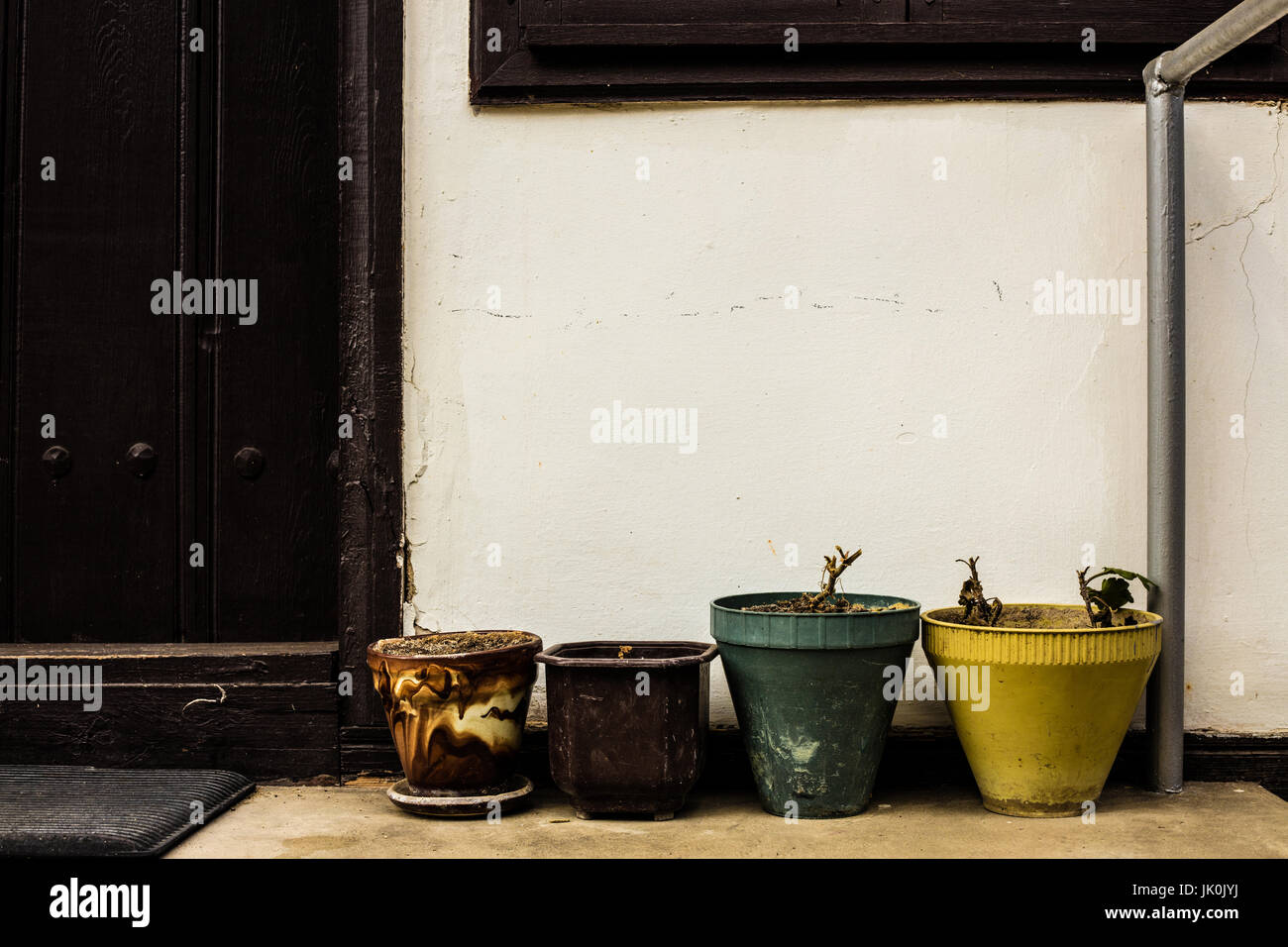 Coloured plant pots on a porch Stock Photo