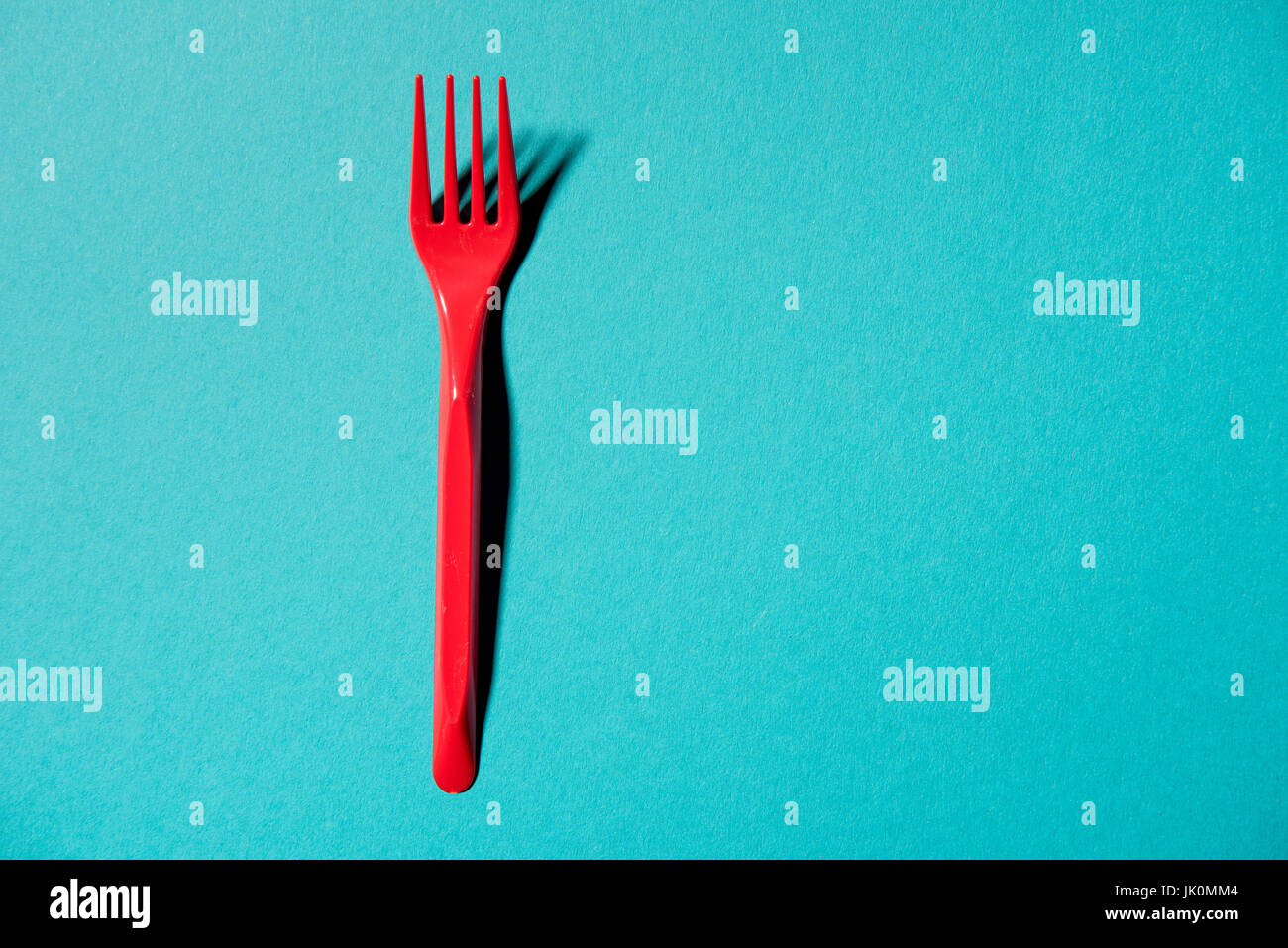 top view of red plastic fork isolated on blue Stock Photo