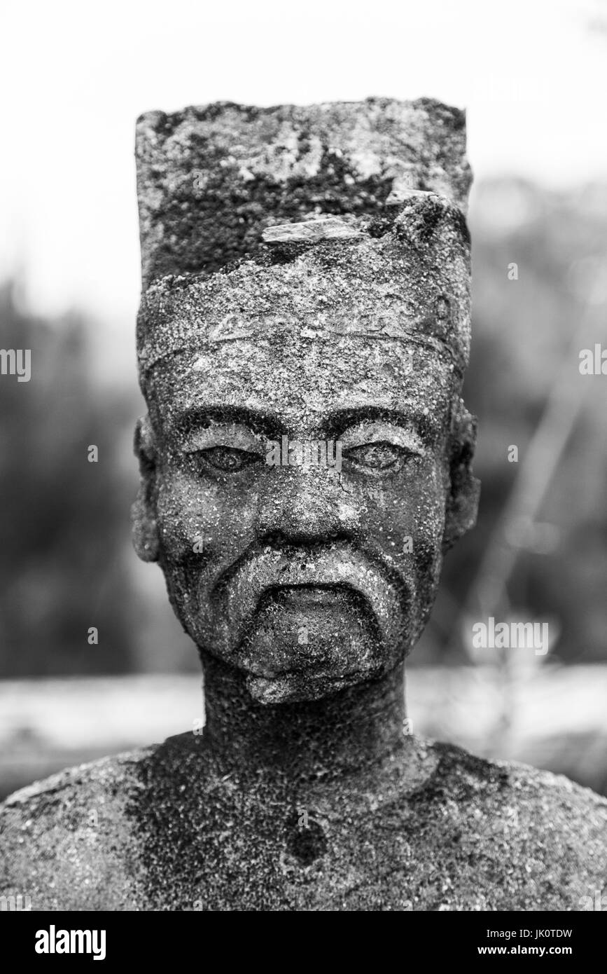 The stone face of a Mandarin (official of the royal court) statue watches over the tomb of Dong Khanh, the 9th Nguyen emperor Stock Photo