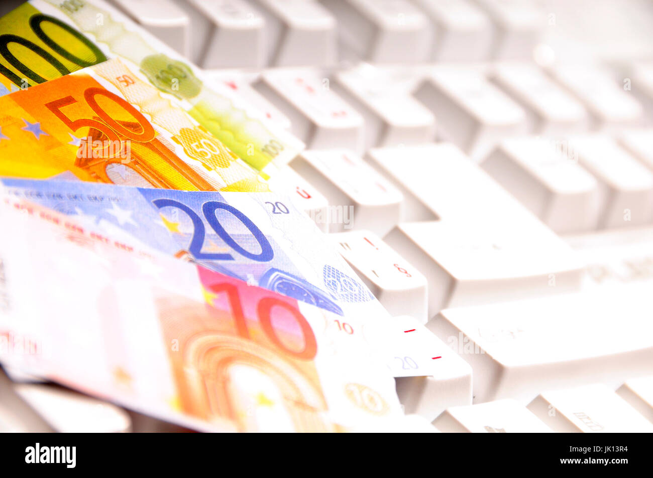 Euro banknotes on a computer keyboard Stock Photo - Alamy