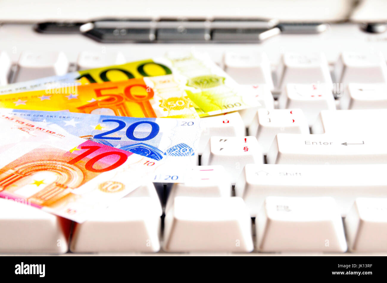 Euro banknotes on a computer keyboard Stock Photo - Alamy