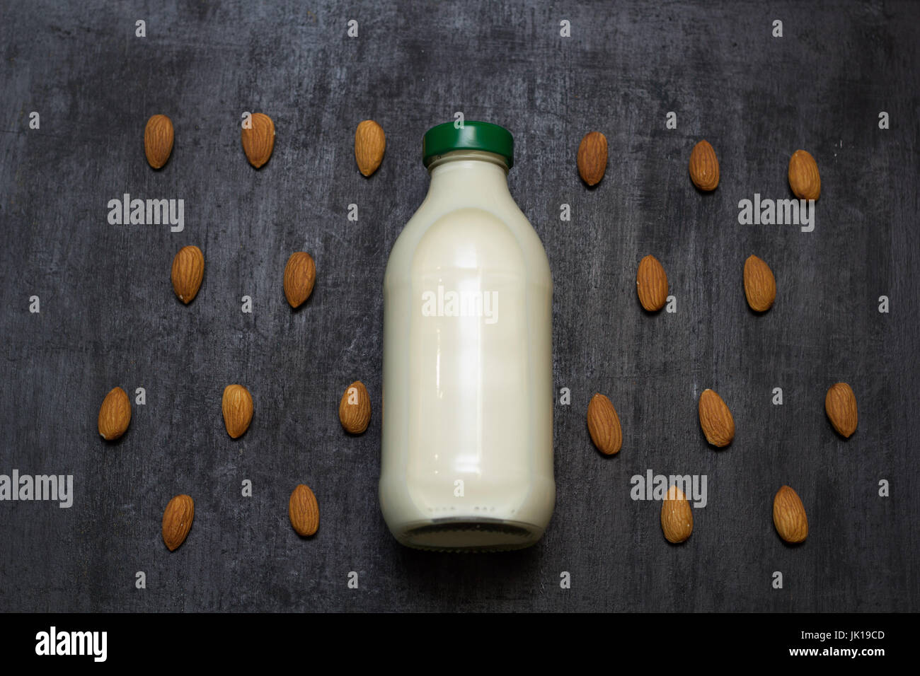 top view bottle of fresh raw vegan almond  milk on a black background Stock Photo