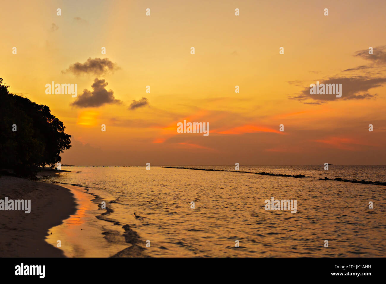 Beautiful tropical sunset on the beach Stock Photo - Alamy