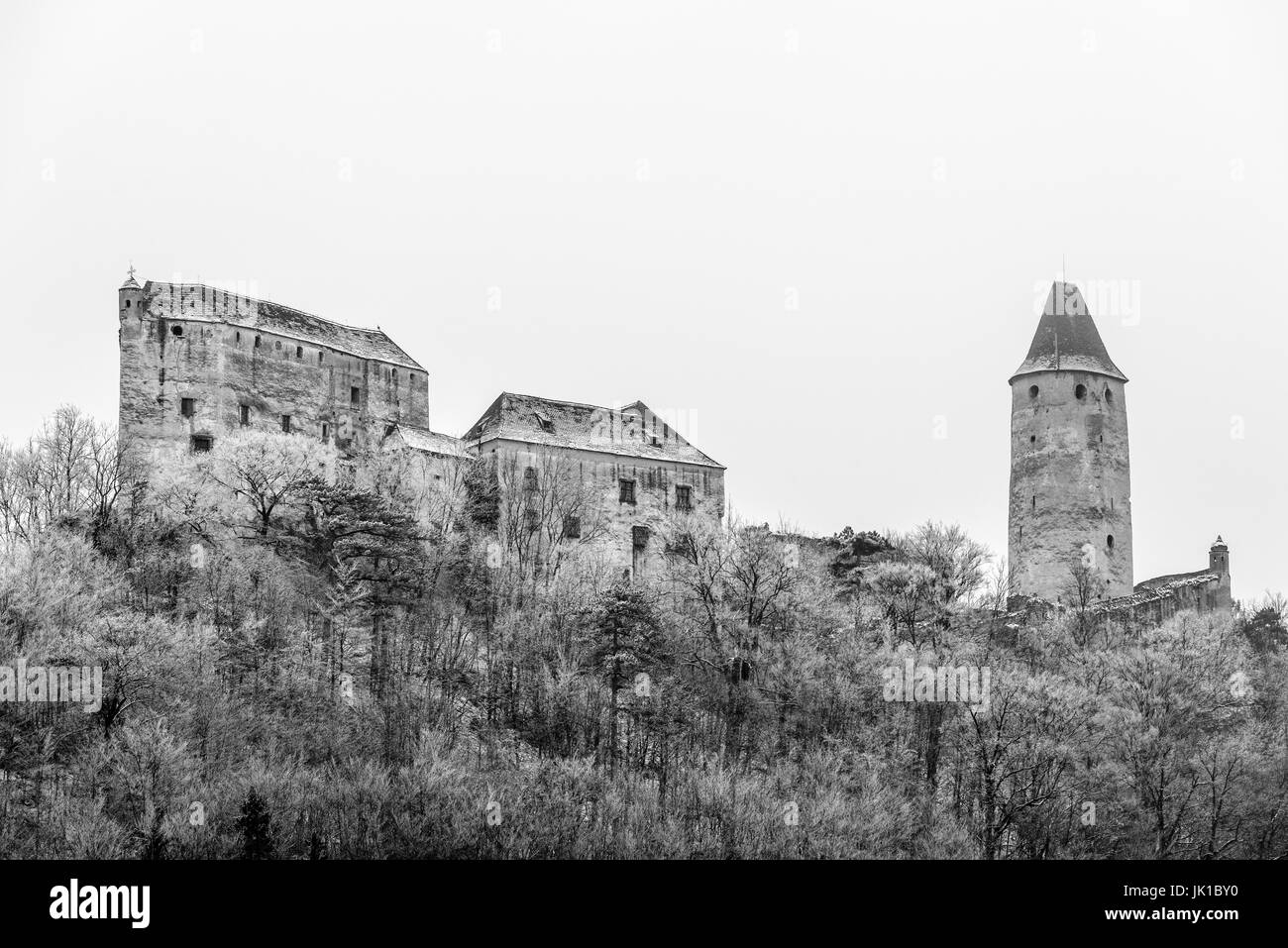 Outdoor scenic monochrome black and white image of medieval castle Seebenstein, Austria, on cold winter day with snow and hoar frost Stock Photo