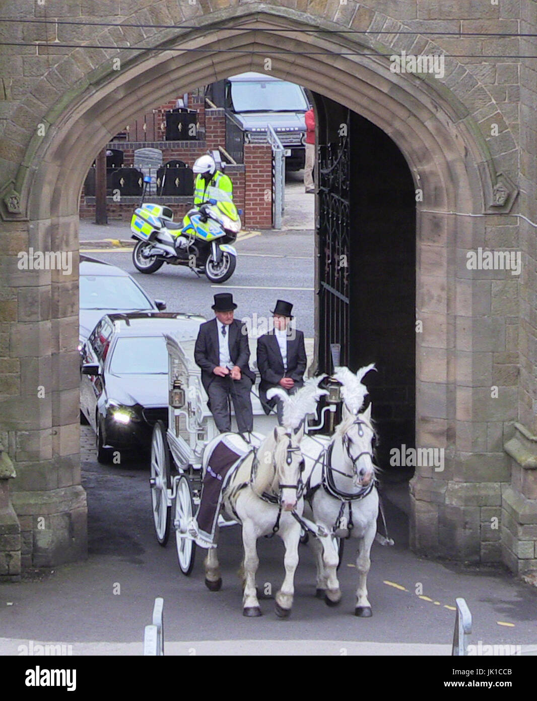 A white horse-drawn hearse carrying the coffin of Kelly Brewster, who died in the Manchester Arena terror attack, arrives at City Road Cemetery in Sheffield for her funeral. Stock Photo
