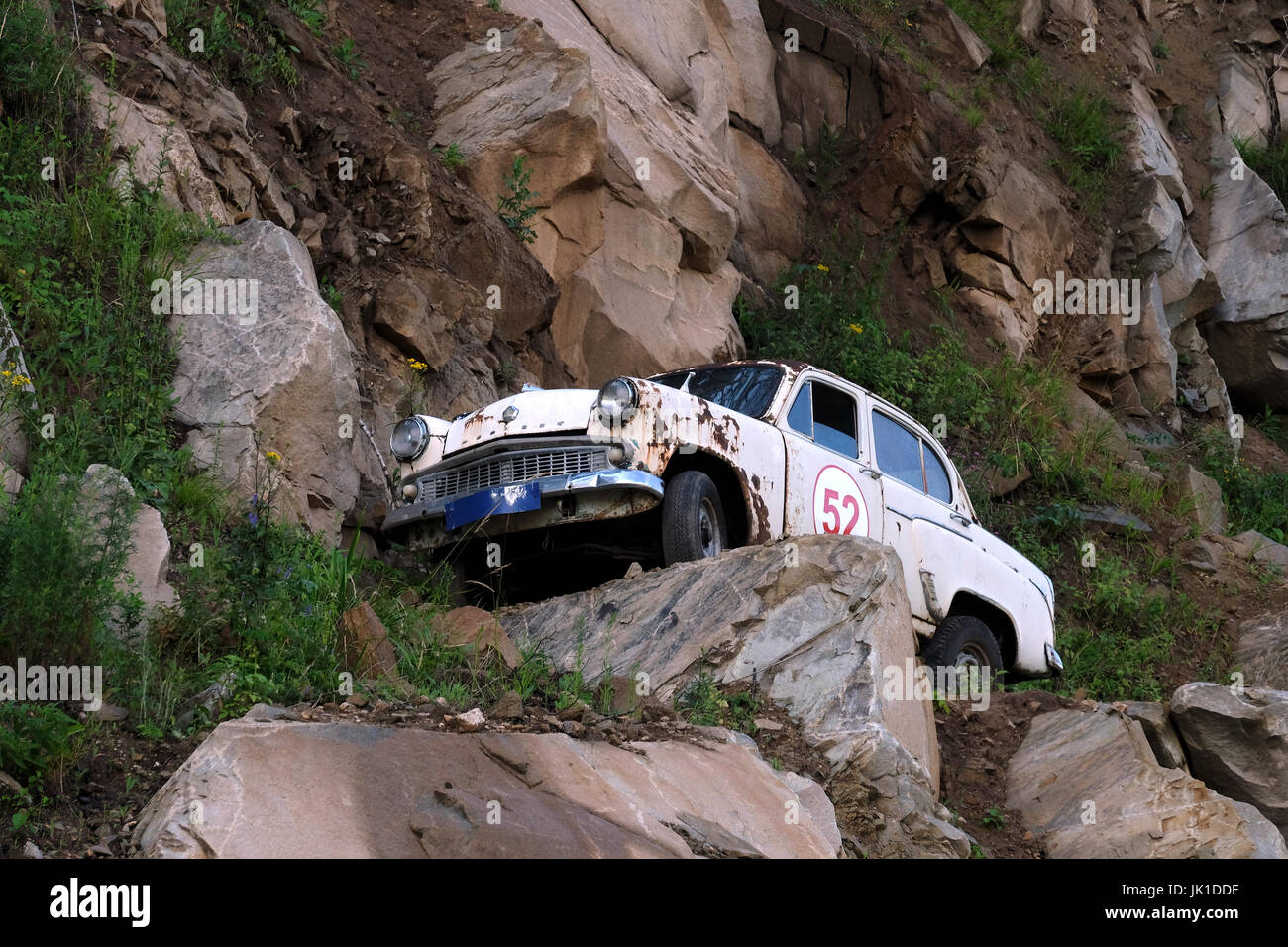 An Old Soviet era Moskvitch car placed on a hillside along the ...