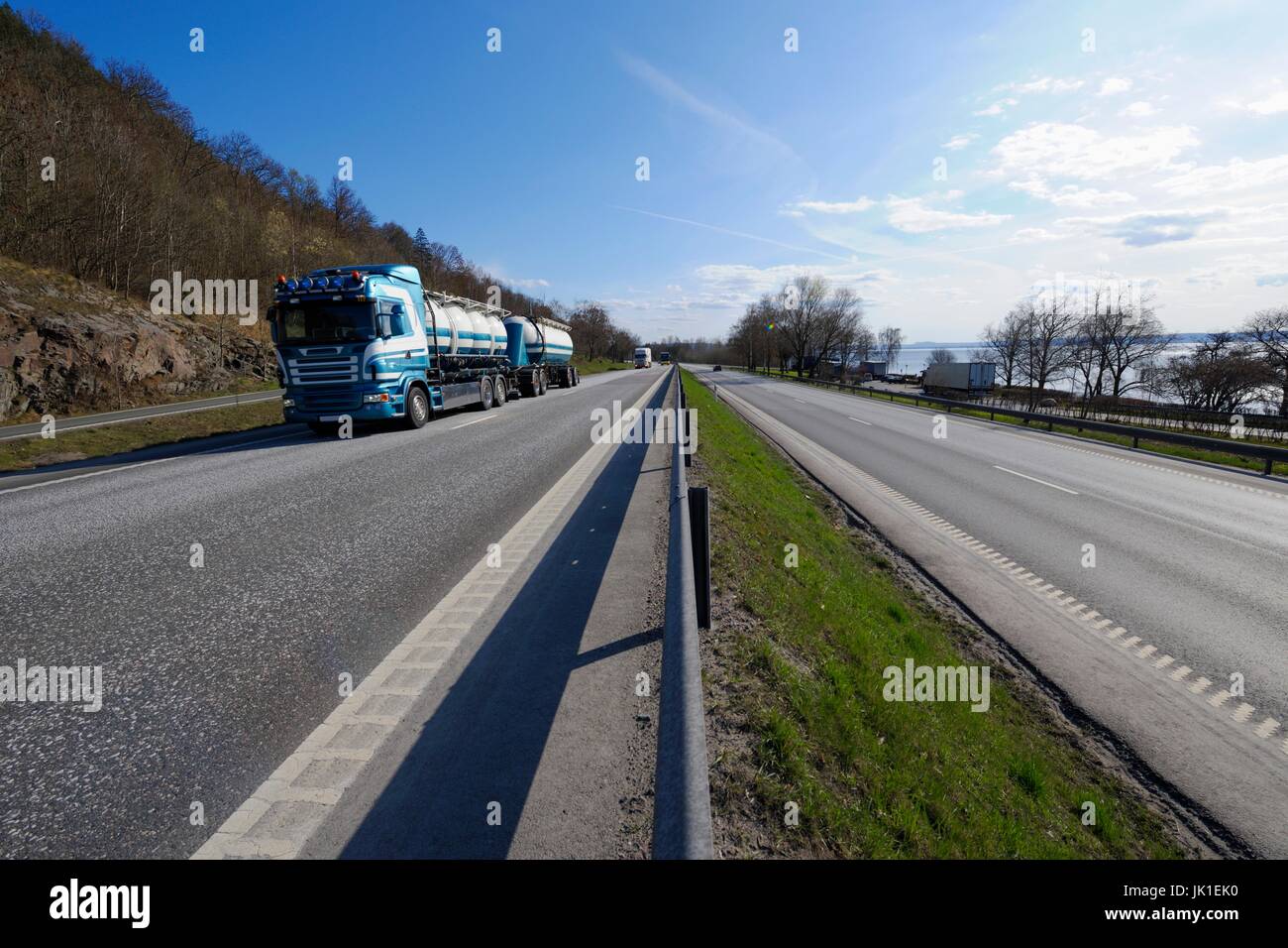 Fuel truck driving on scenic highway,ground perspective. Stock Photo