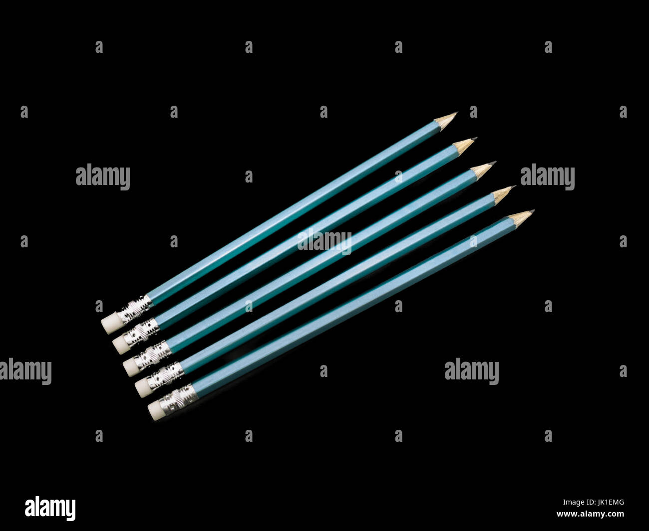 Five Pencils metalic blue and diagonaly positioned on a black background. Stock Photo