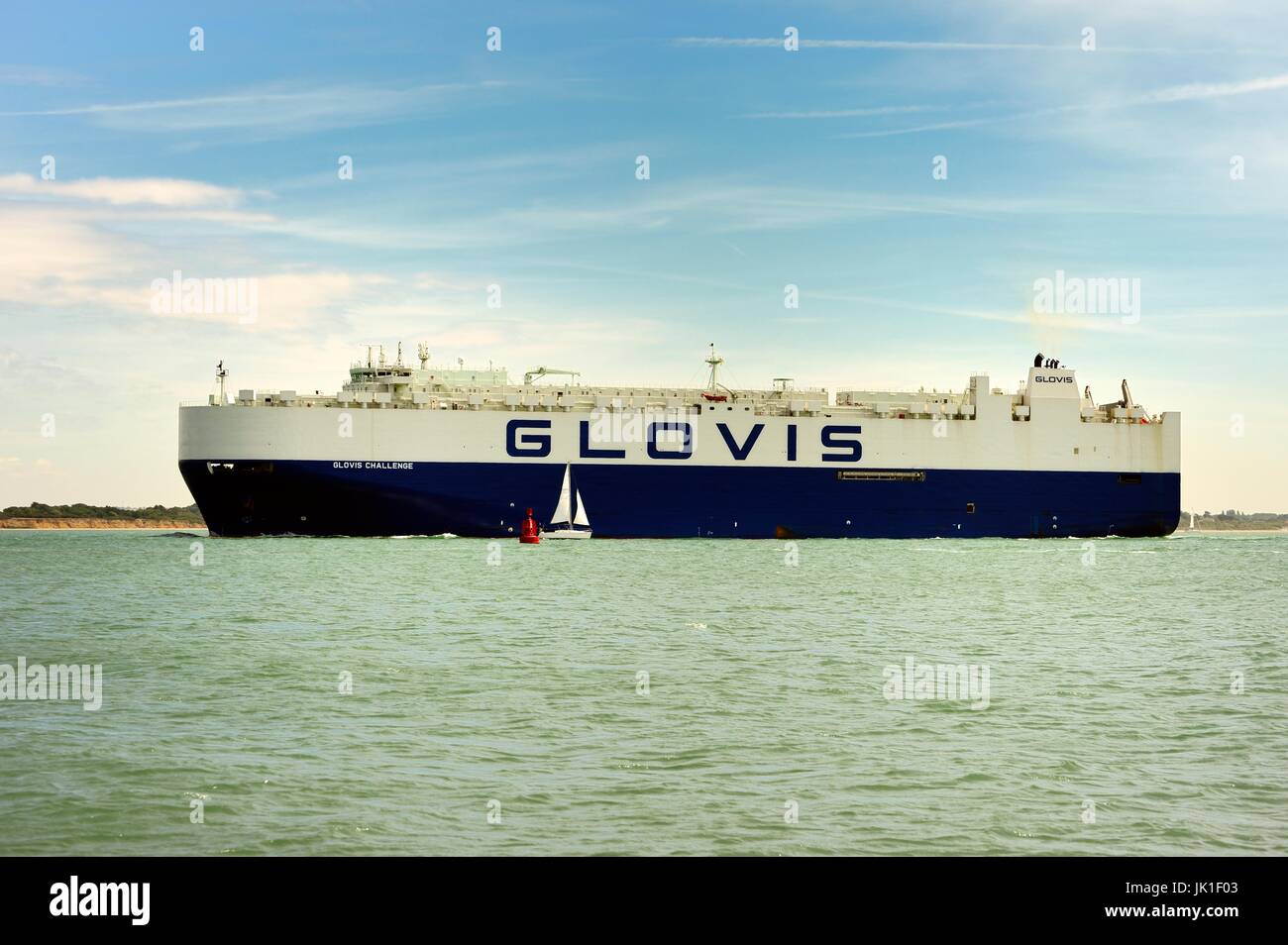 Cargo ship entering Southampton harbour Stock Photo