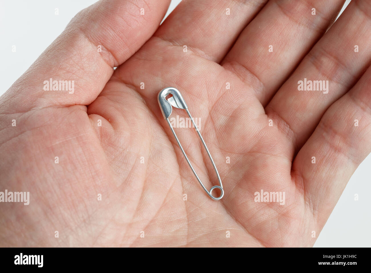 Hand holding sewing safety pins, close up Stock Photo Alamy