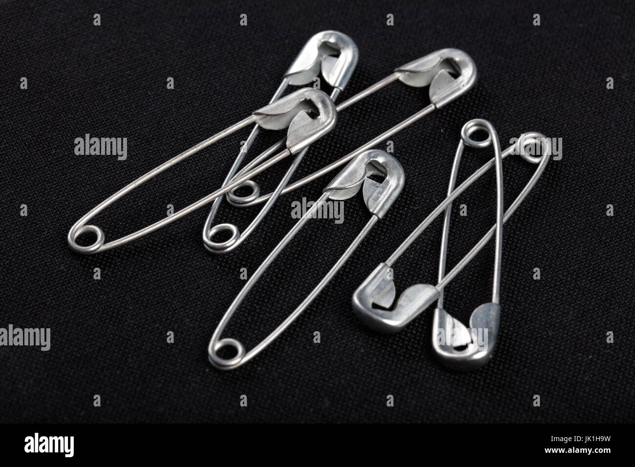 sewing safety pin on a black background Stock Photo Alamy