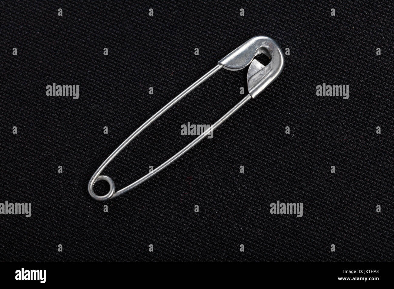 sewing safety pin on a black background Stock Photo Alamy