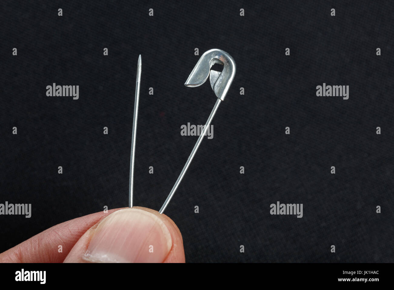 sewing safety pin on a black background Stock Photo Alamy