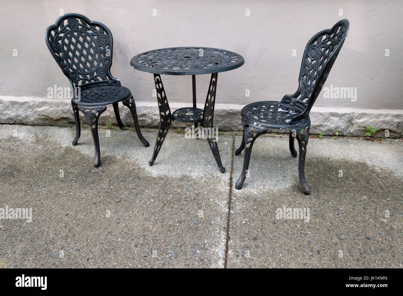 Black Cast Iron Table And Chairs Outside Wet Floor Stock Photo Alamy