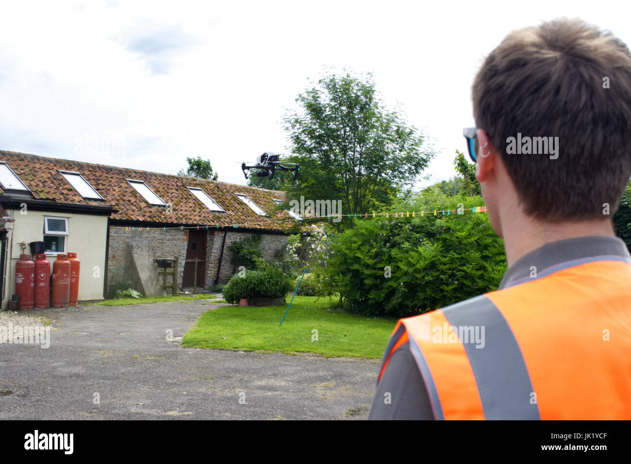 Licensed Drone Operator flying DJI Inspire 1 at a property in the UK Stock Photo