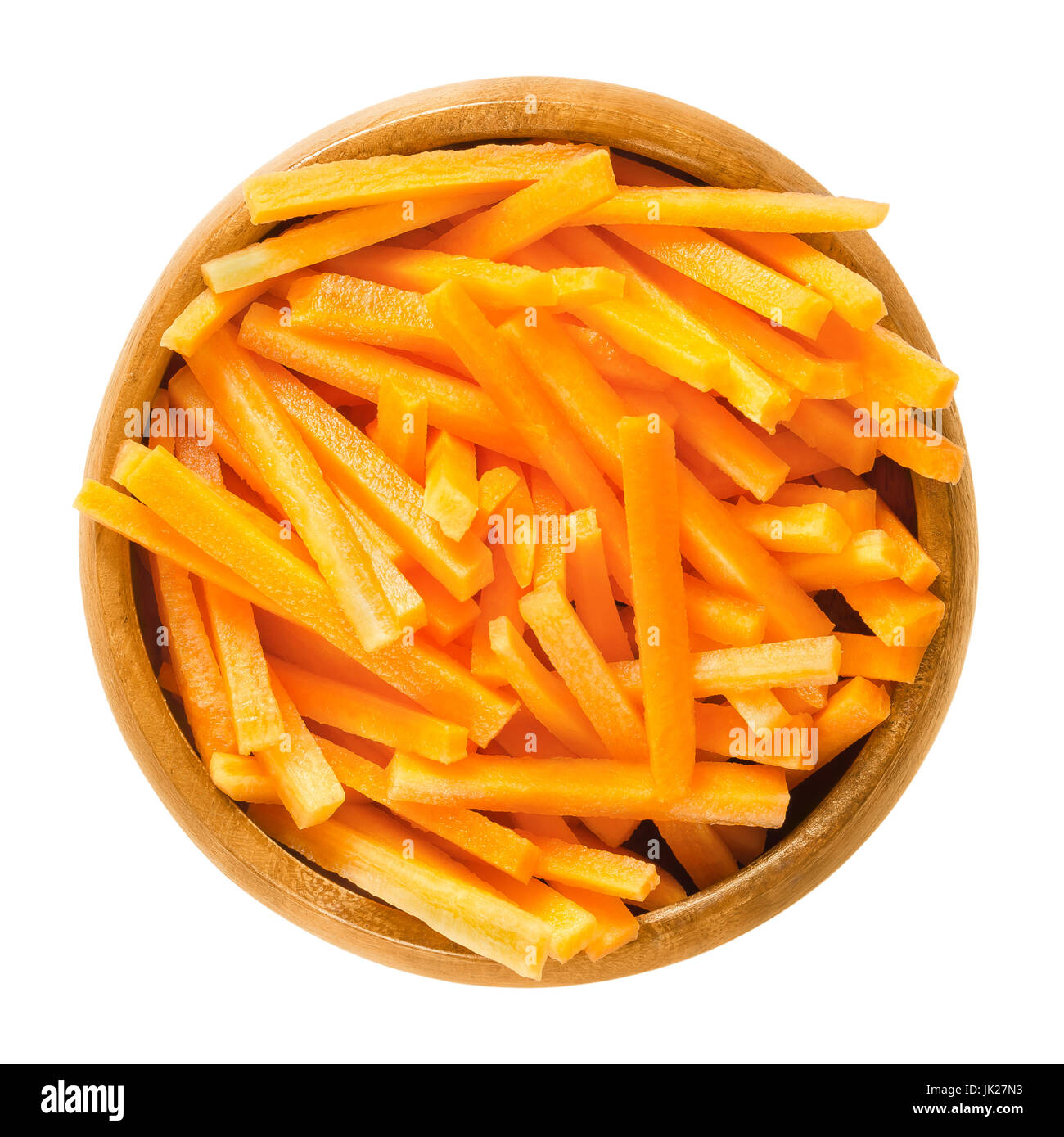 Carrot sticks in wooden bowl. Fresh cut crisp strips of Daucus carota, a root vegetable with orange color. Edible taproot pieces. Photo. Stock Photo