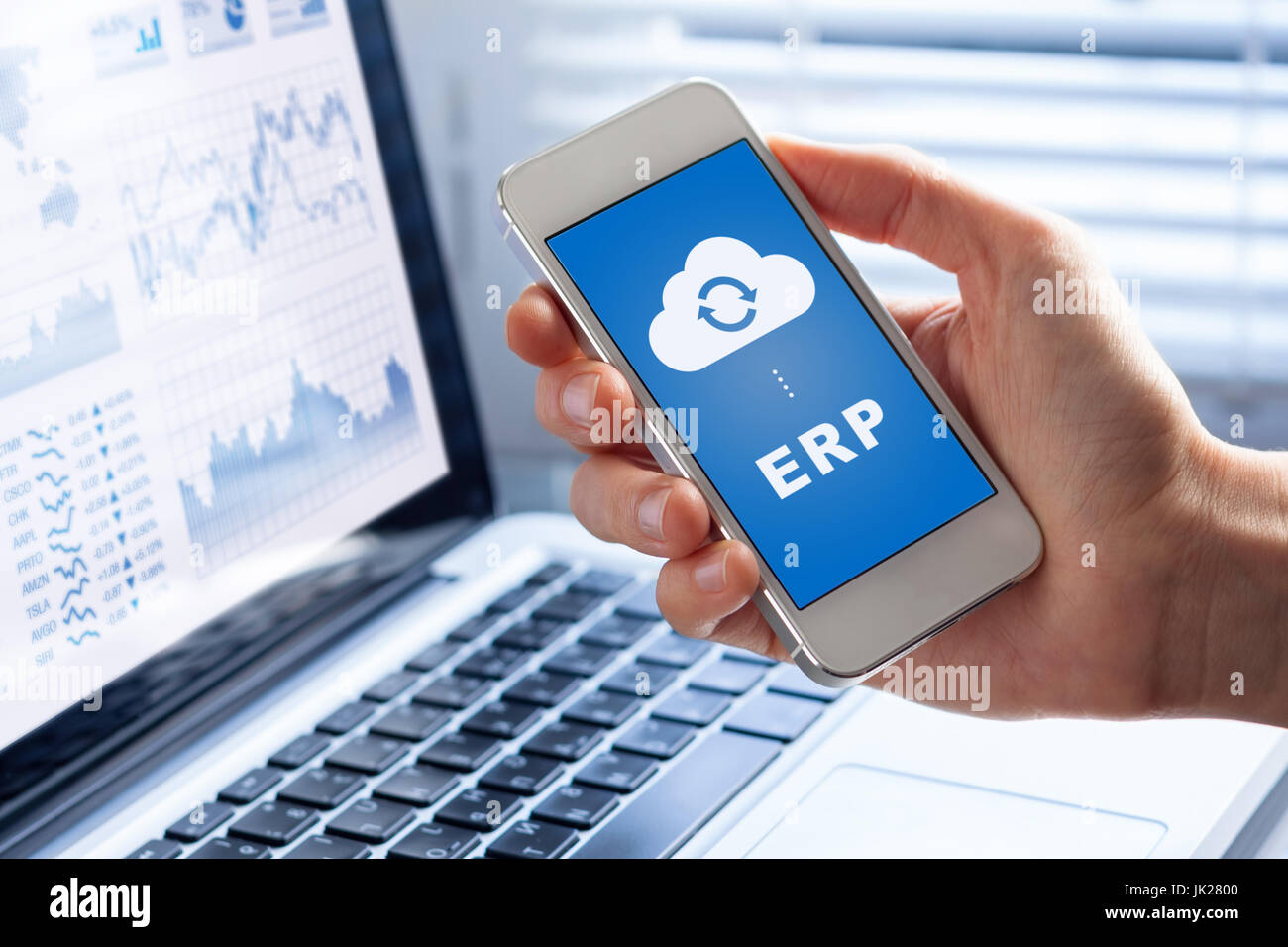 ERP (Enterprise Resource Planning) app on smartphone screen connecting data with cloud computing, access to HR management, production control, account Stock Photo