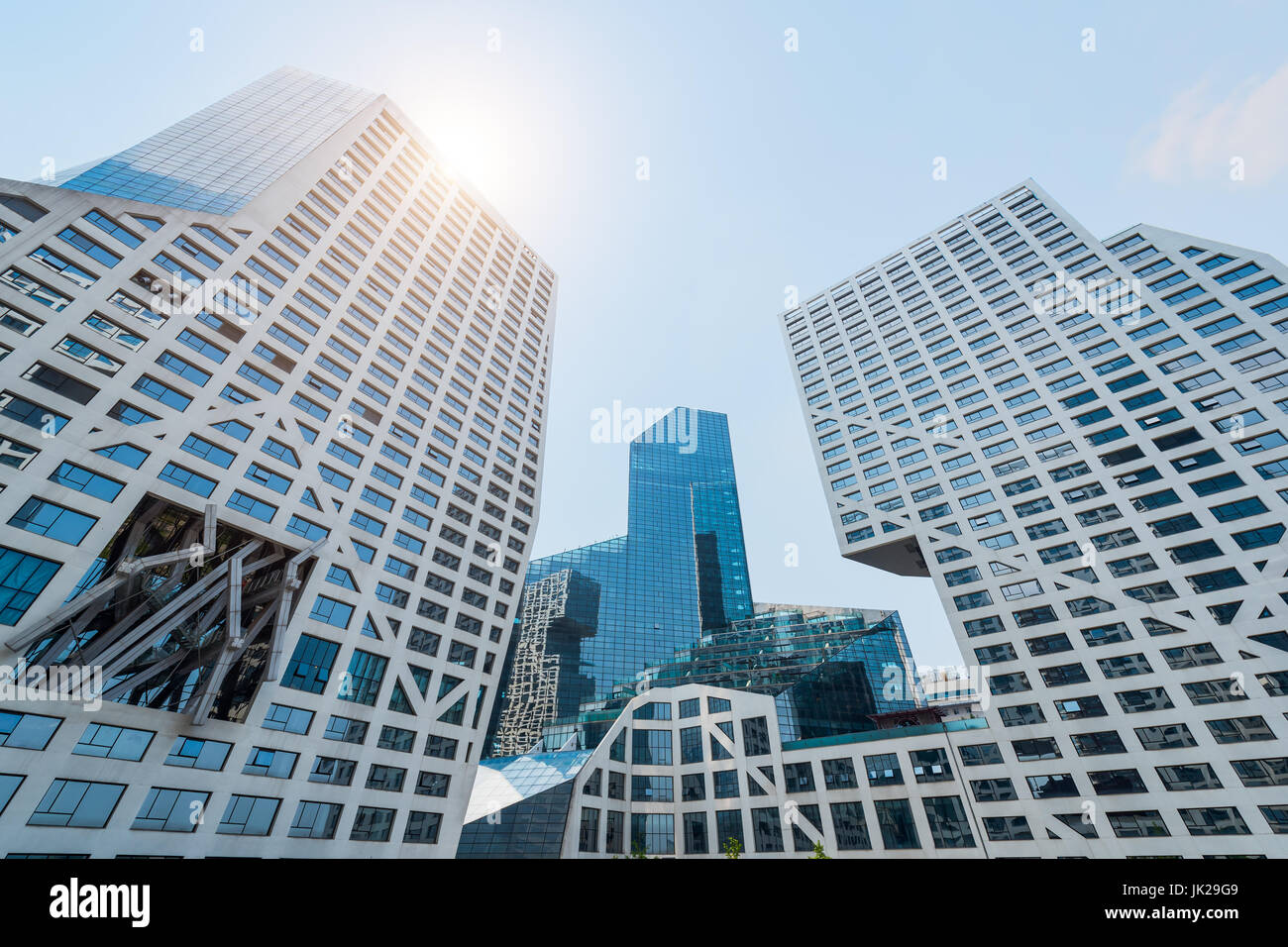Modern buildings against blue sky and sun Stock Photo - Alamy