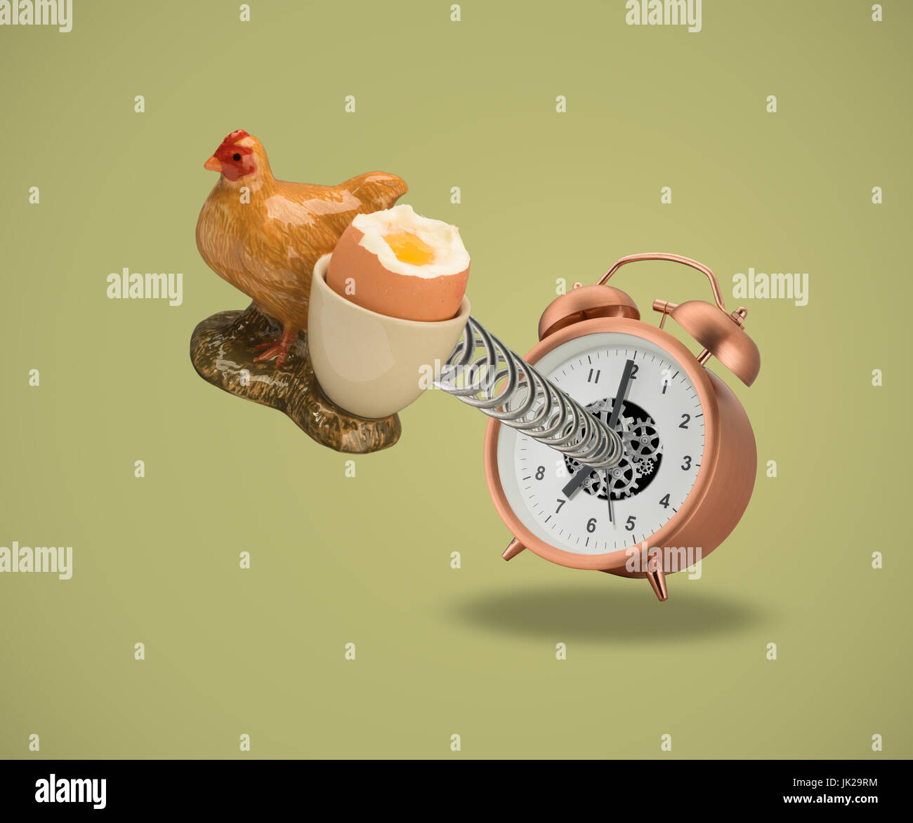 Hen Egg cup springing out of alarm clock Stock Photo