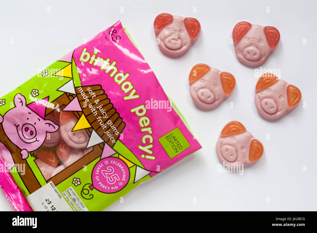 Bag of M&S birthday percy! percy pig sweets celebrating 25 years of Percy Pig opened to show contents set on white background Stock Photo