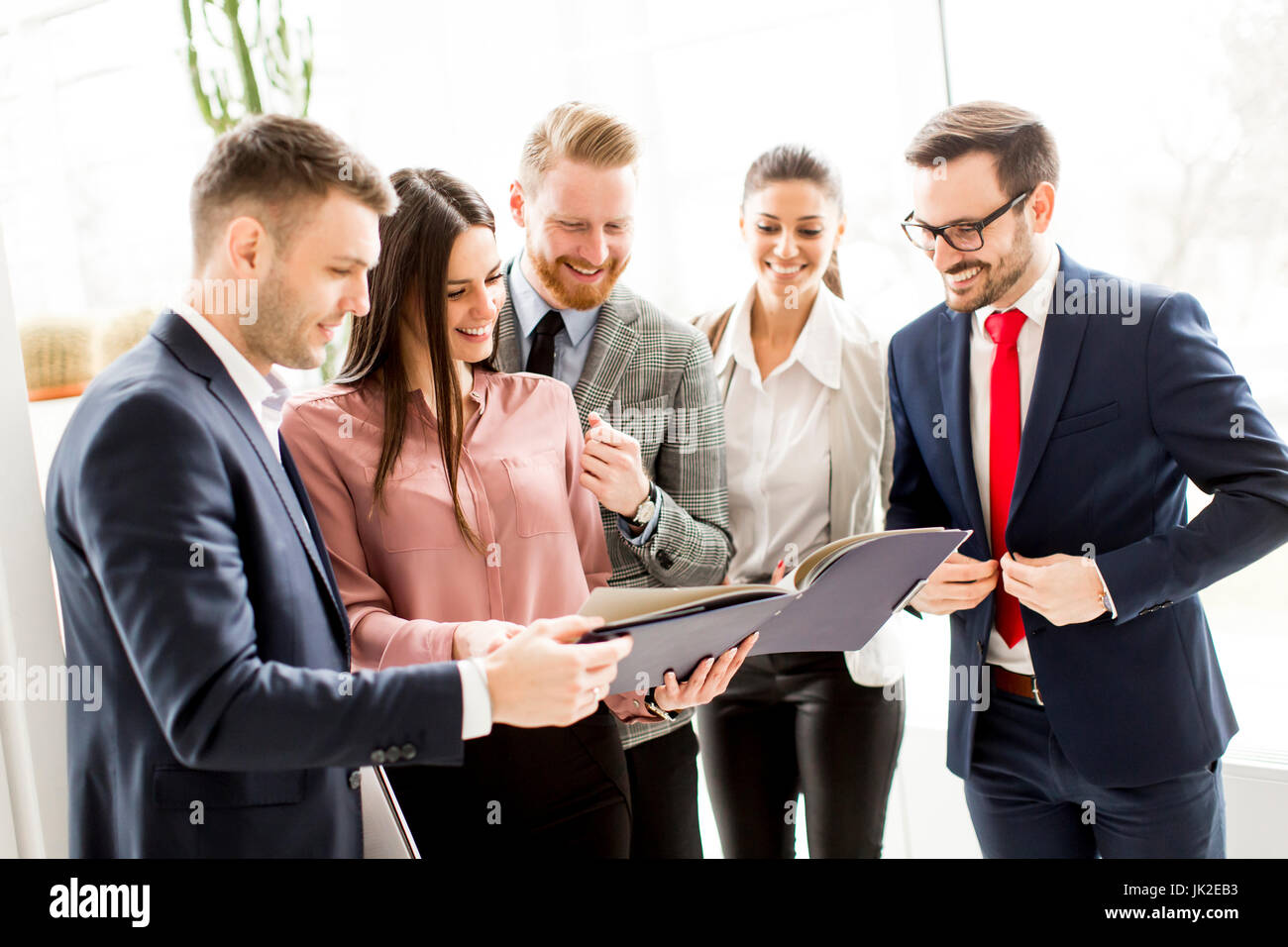 Group of businesspeople standing in the modern bright office Stock ...