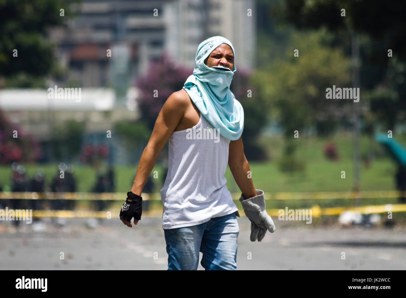 A demonstrator under the effects of tear gas during a protest in Caracas against president Nicolas Maduro. Stock Photo