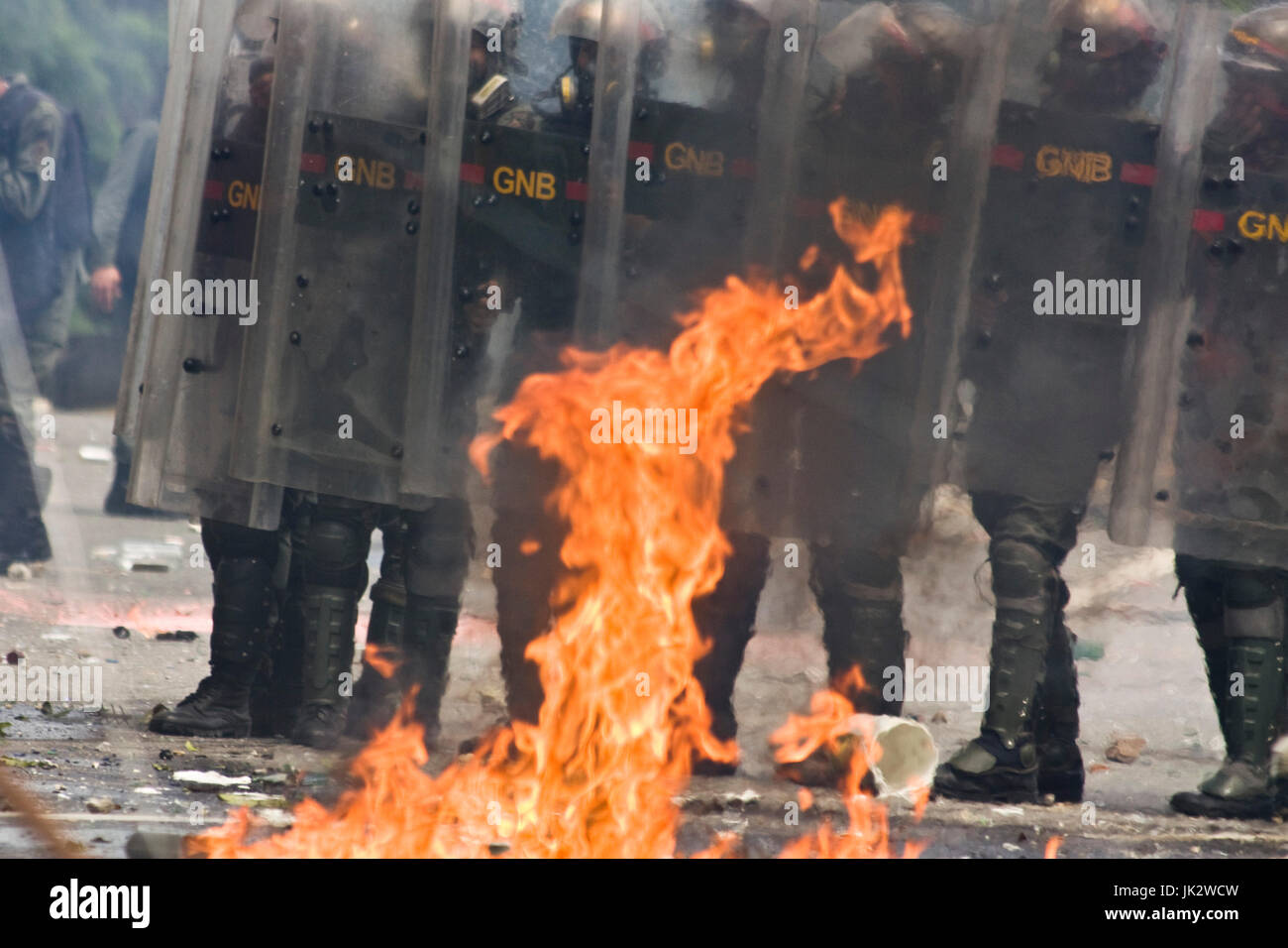 The Bolivarian National Guard try to disperse a group of demonstrators that were blocking the streets in Caracas protesting against president Maduro. Stock Photo