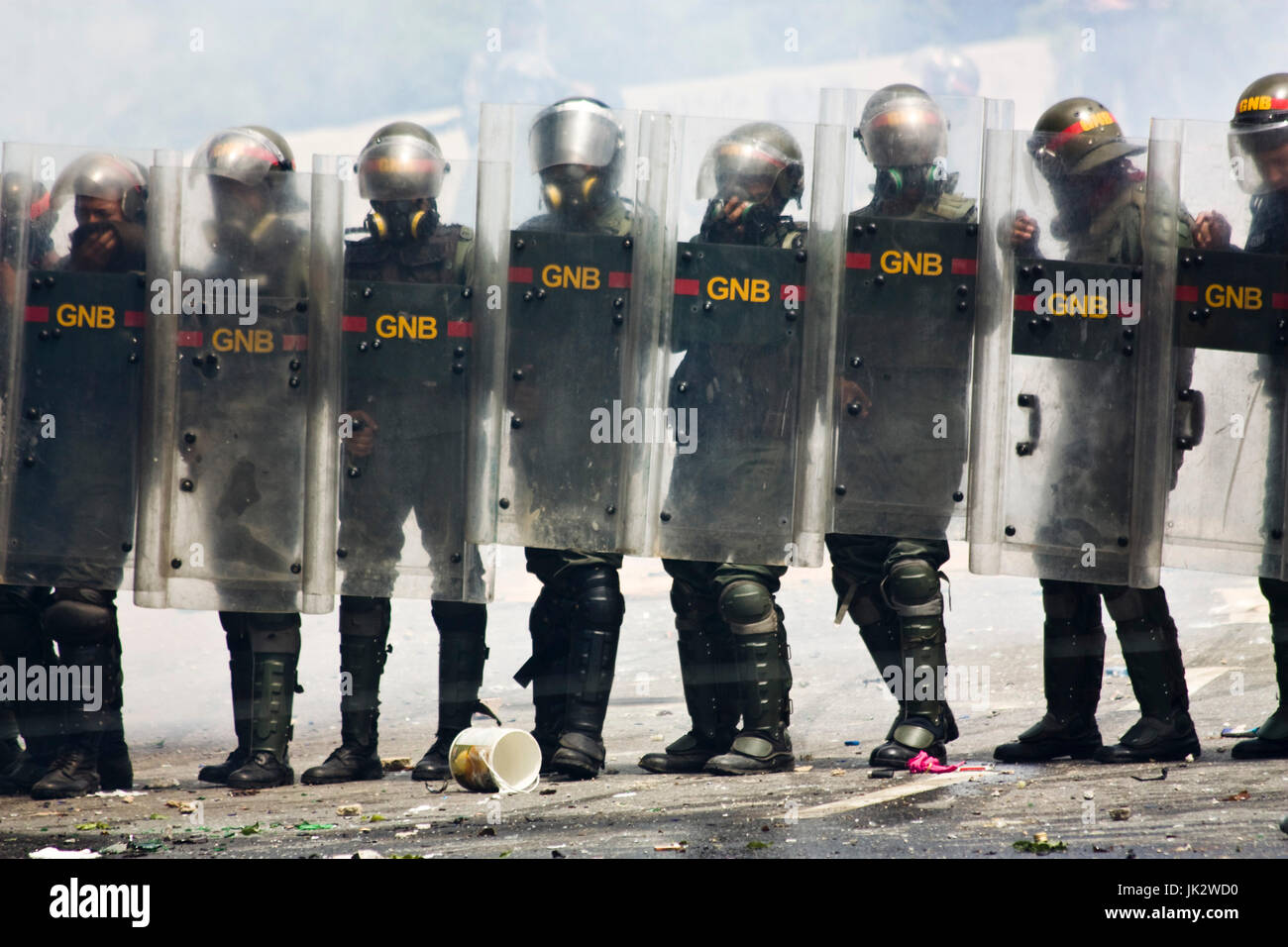 The Bolivarian National Guard try to disperse a group of demonstrators that were blocking the streets in Caracas protesting against president Maduro. Stock Photo