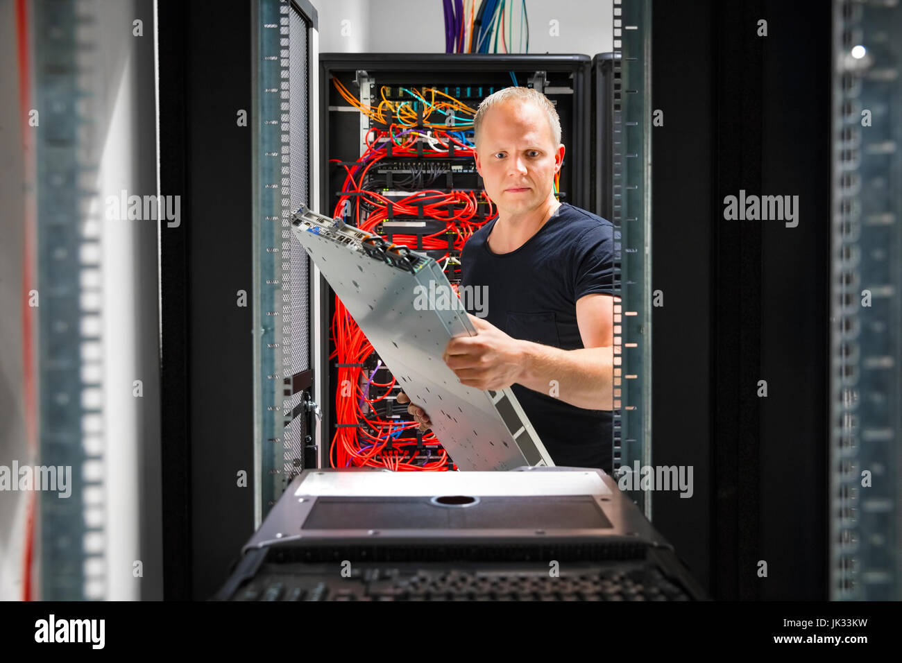 IT Engineer Arranging Server At Datacenter Stock Photo