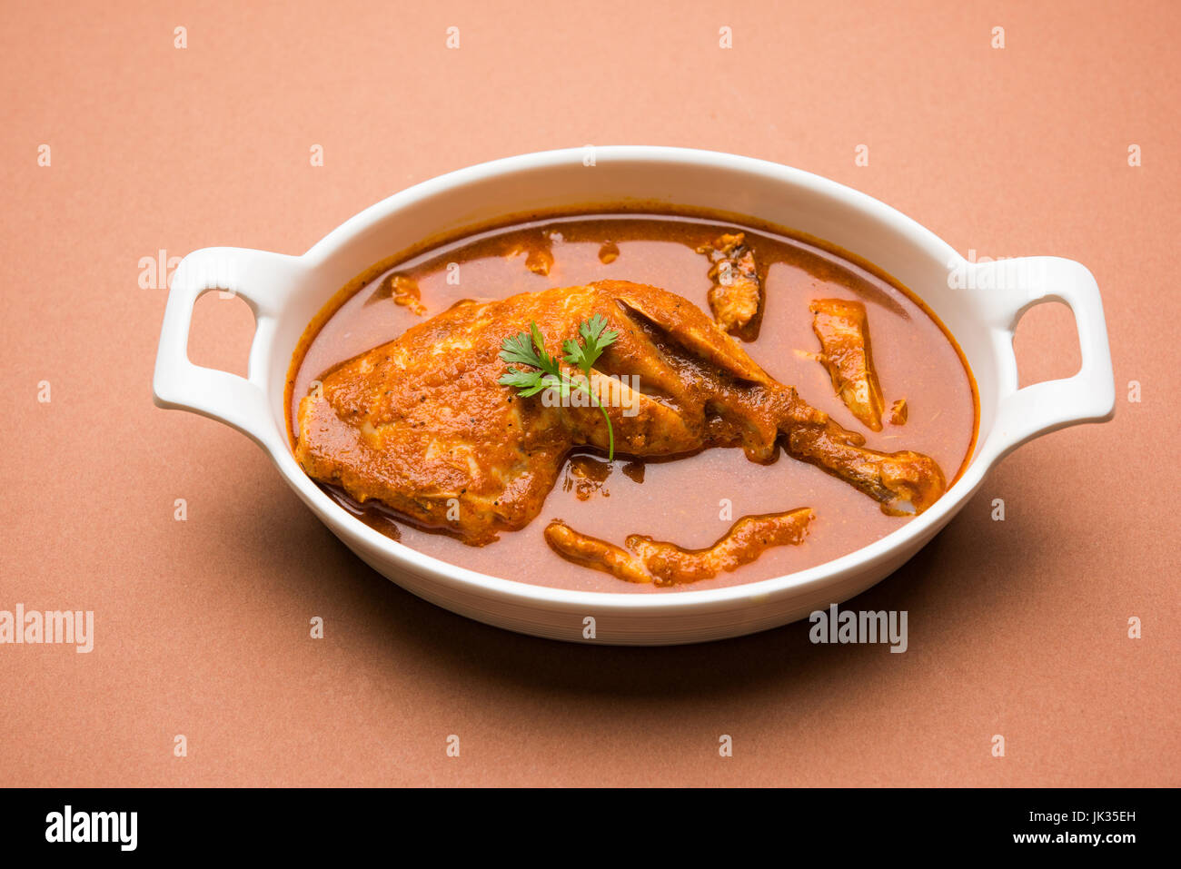 Indian spicy Chicken curry or masala chicken with prominent leg piece