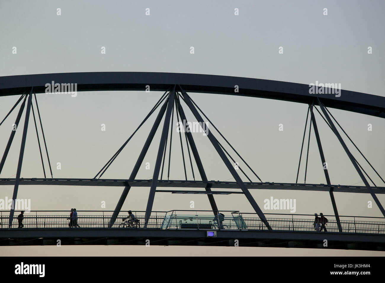 Pedestrian and bike traffic on the goodwill bridge at dusk hires stock