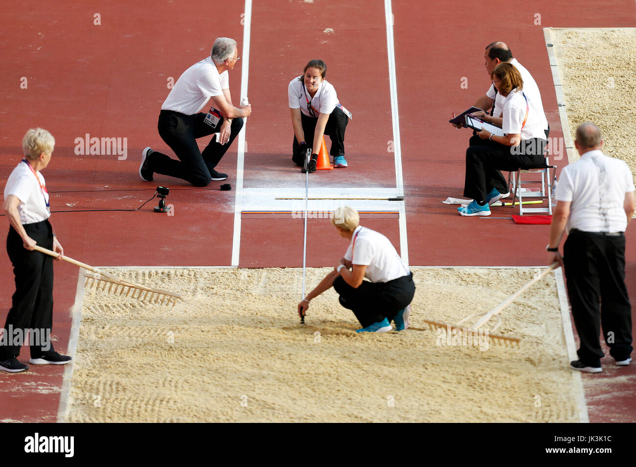 Officials measuring the distance in the Women's Long Jump T12 Final