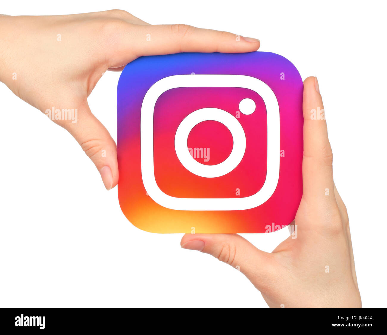 Kiev, Ukraine - January 20, 2016: Hands hold Instagram icon printed on paper. Instagram is an online mobile photo-sharing, video-sharing service Stock Photo