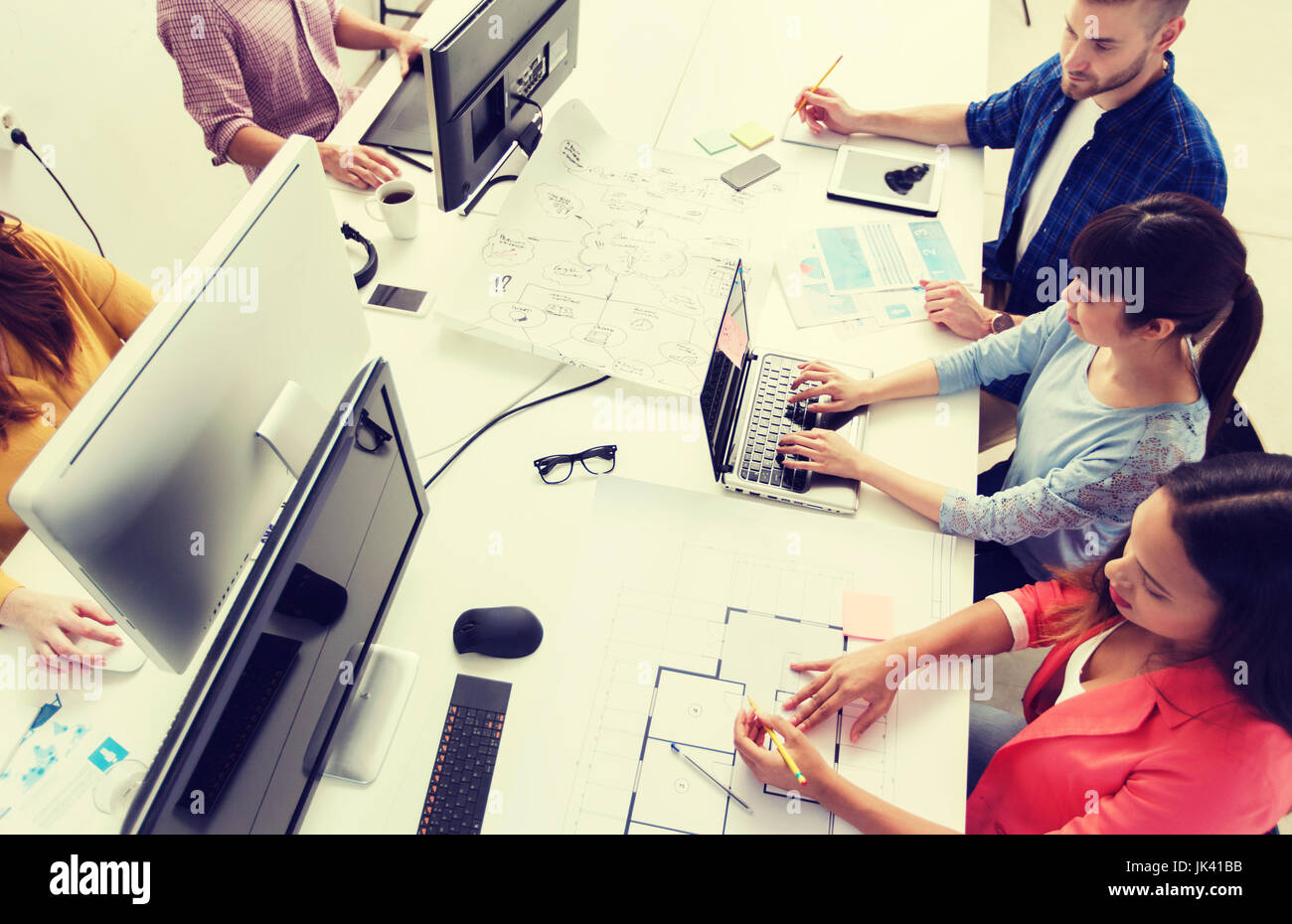 creative team with computers, blueprint at office Stock Photo - Alamy