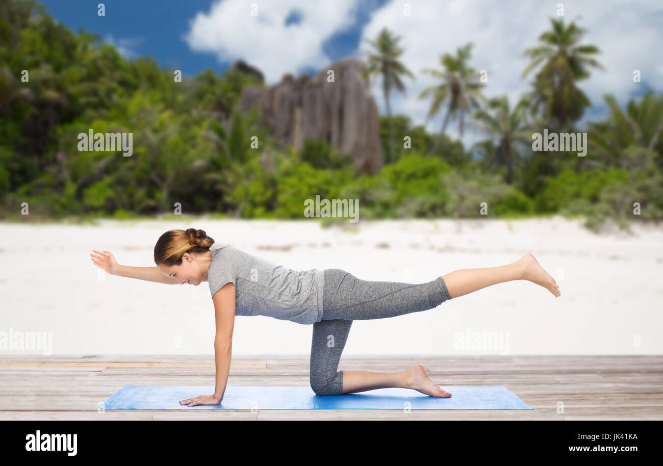 woman doing yoga in balancing table pose on beach Stock Photo Alamy