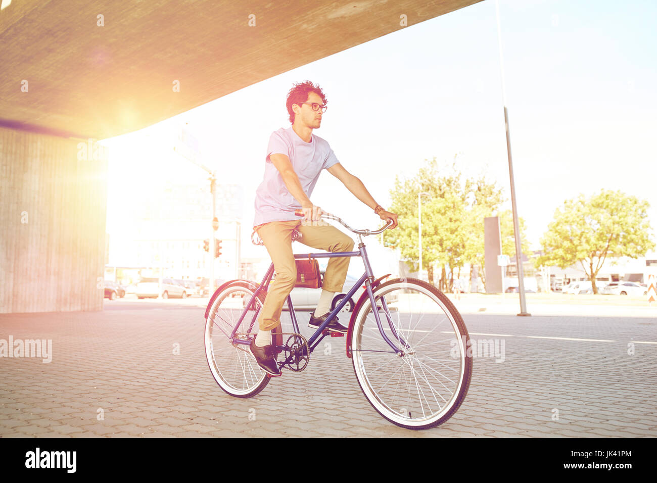 young hipster man riding fixed gear bike Stock Photo