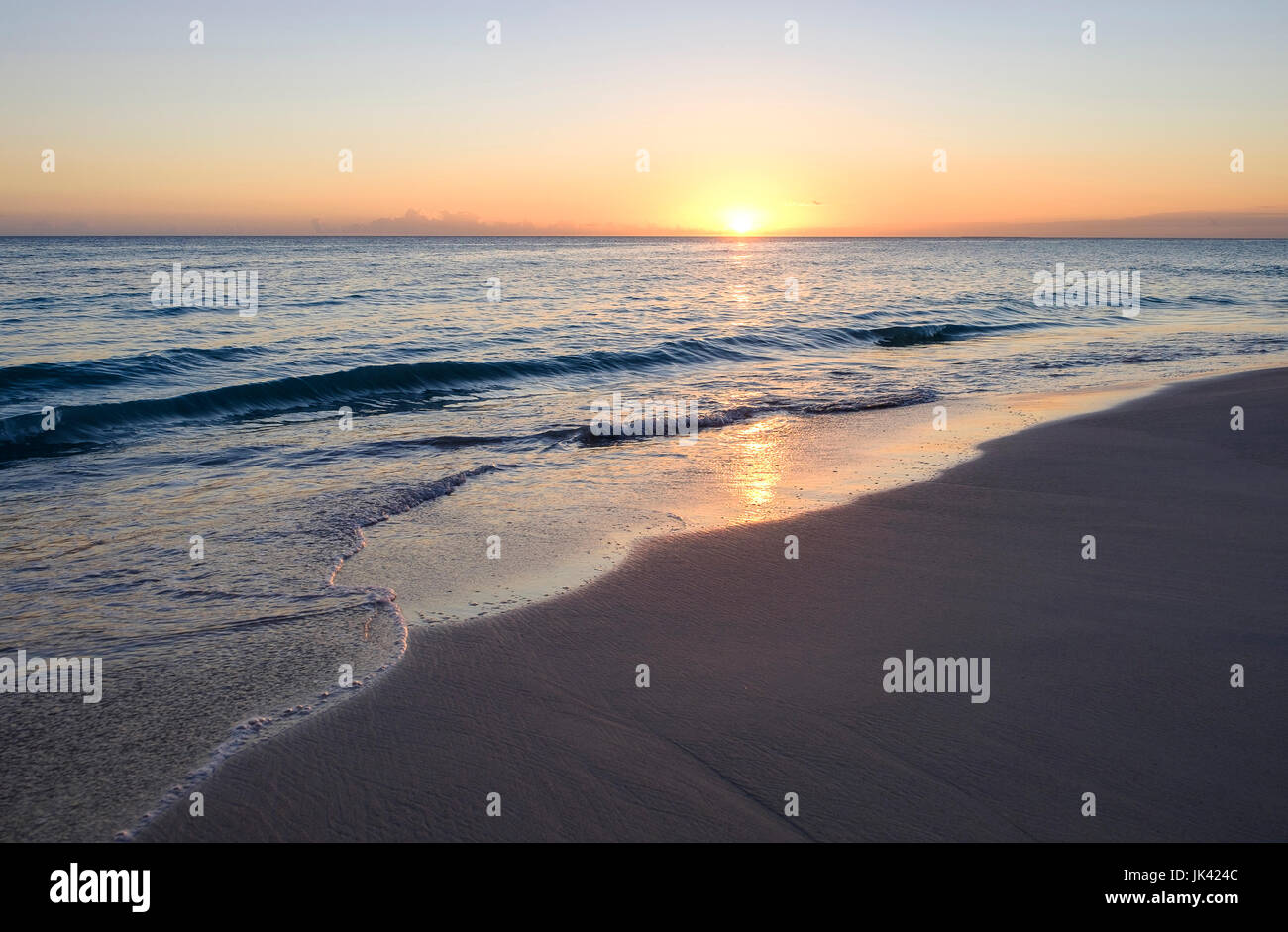 Sunset on ocean beach Stock Photo